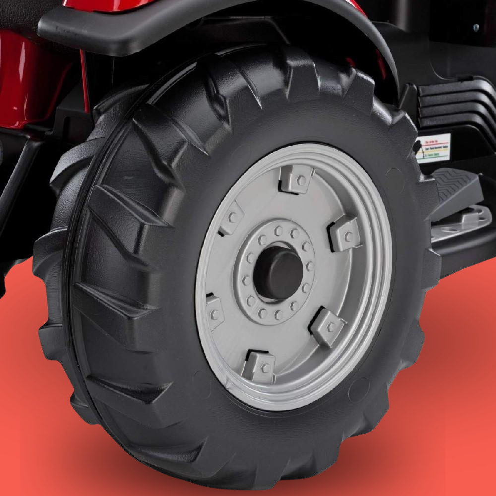 Close-up of a black tire with tread pattern on a red background