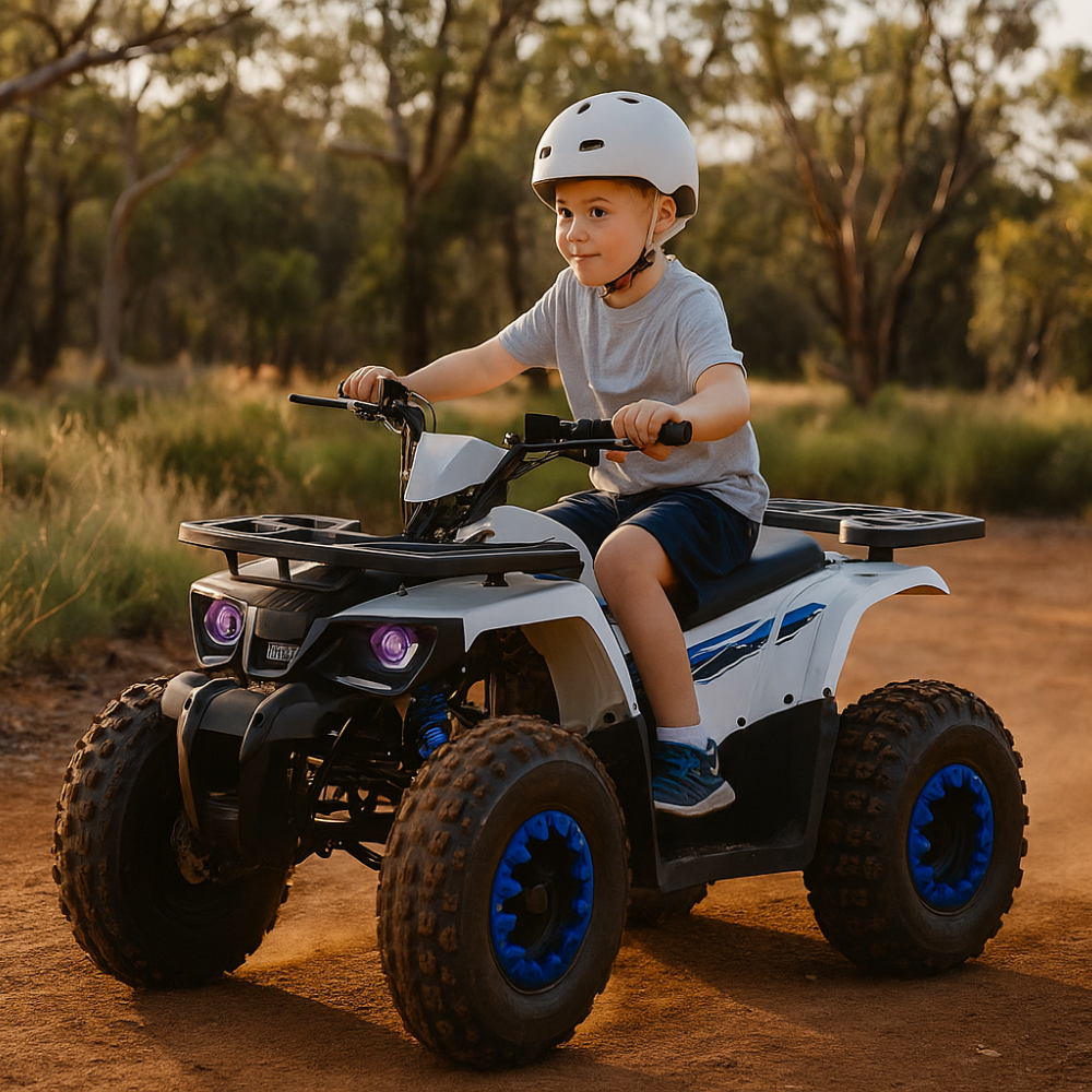 Child riding a white electric quad bike outdoors on a dirt trail, wearing a white helmet and smiling.