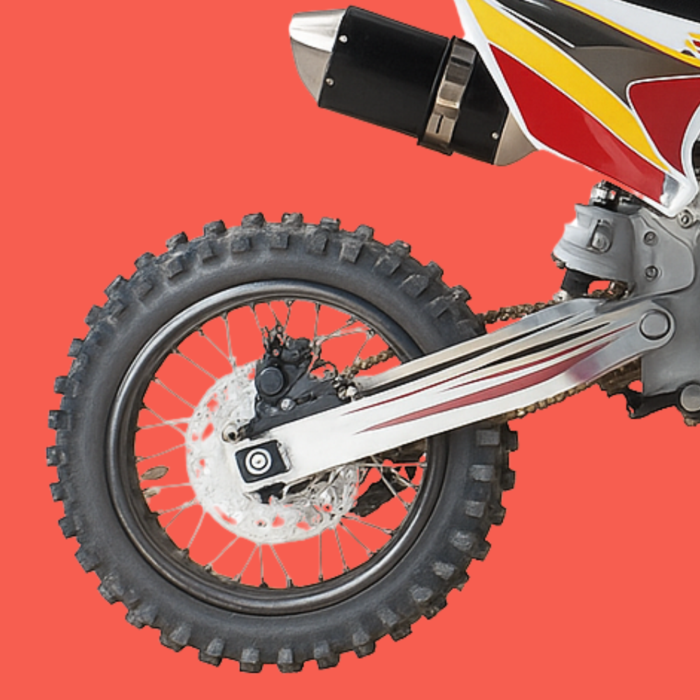 Rear wheel and suspension close-up of the GMX 125cc dirt bike highlighting the knobby tyre and alloy swingarm.