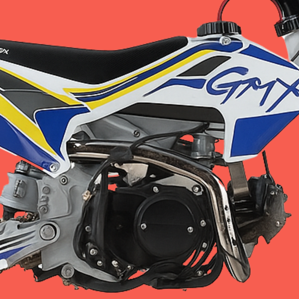 Close-up view of the GMX 125cc dirt bike engine and foot peg assembly with bold graphics.