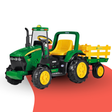 Toy tractor with yellow trailer on a white background