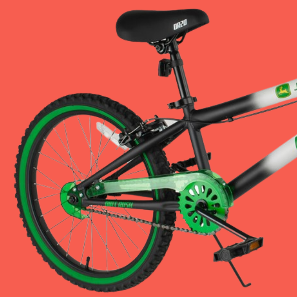 Children's bicycle with green wheels on a red background