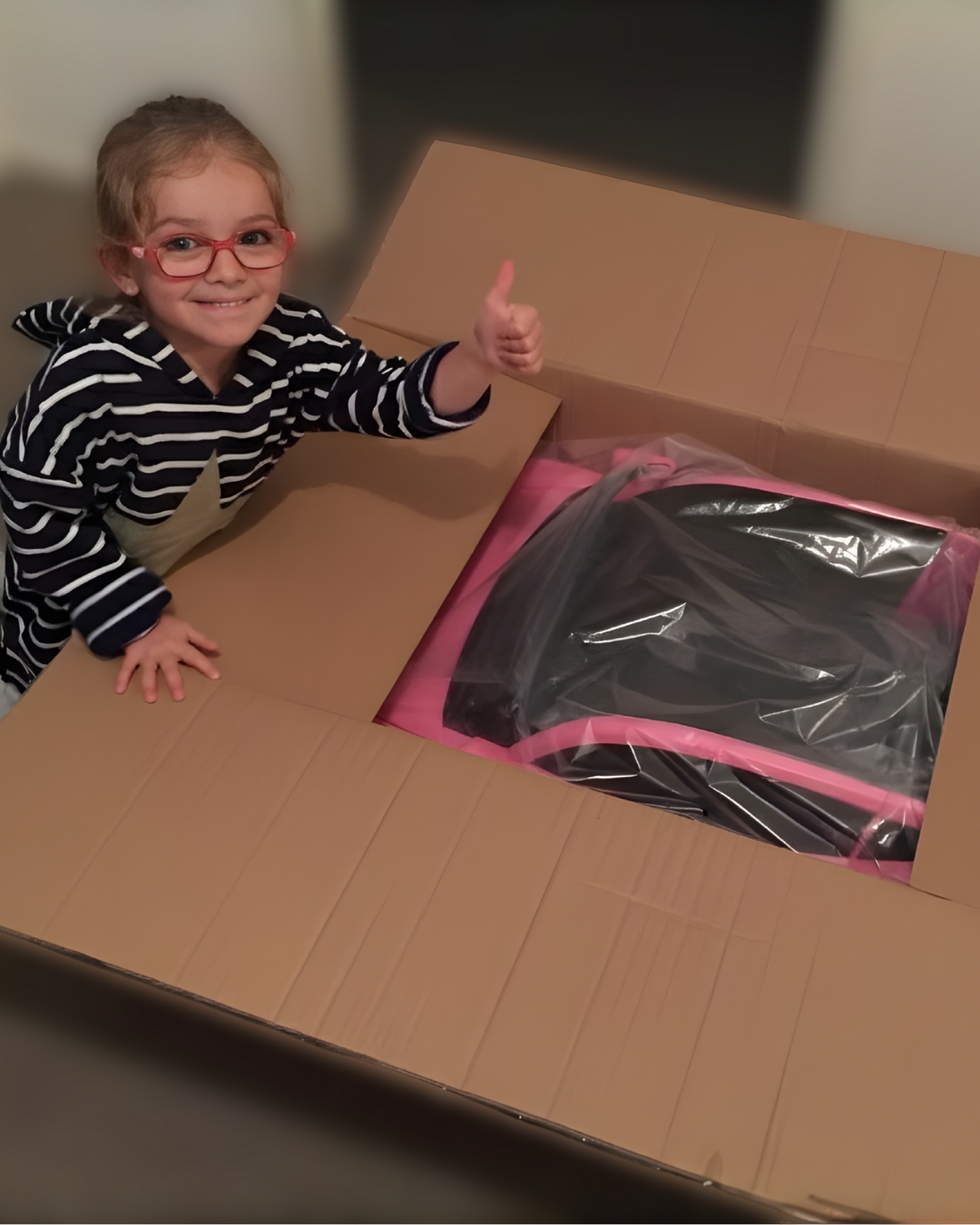 Child unboxing a toy packaging with thumbs up sign