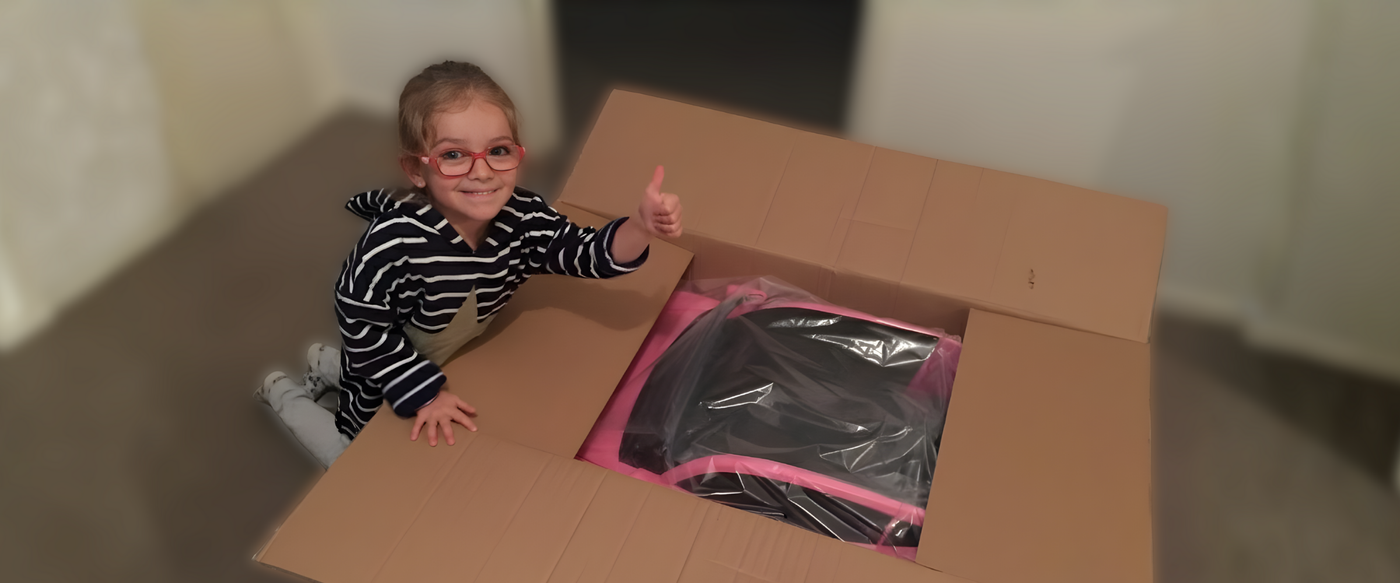 Child unboxing a toy packaging with thumbs up sign
