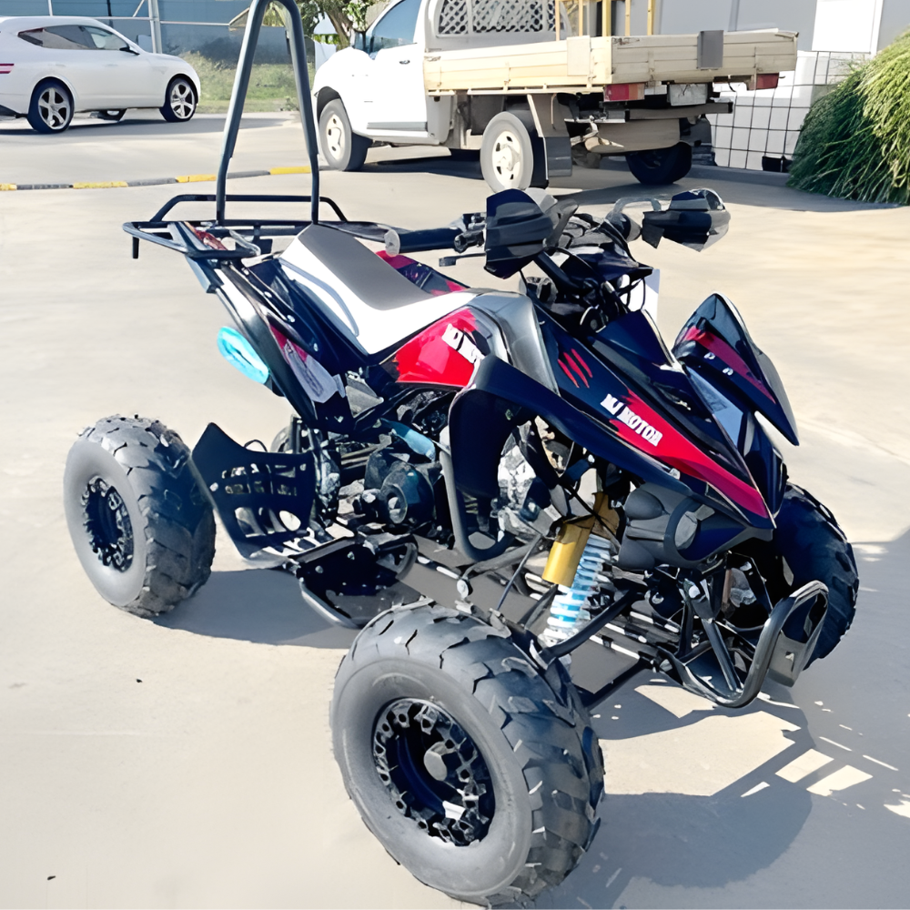 Black and red ATV on a paved road with vehicles in the background