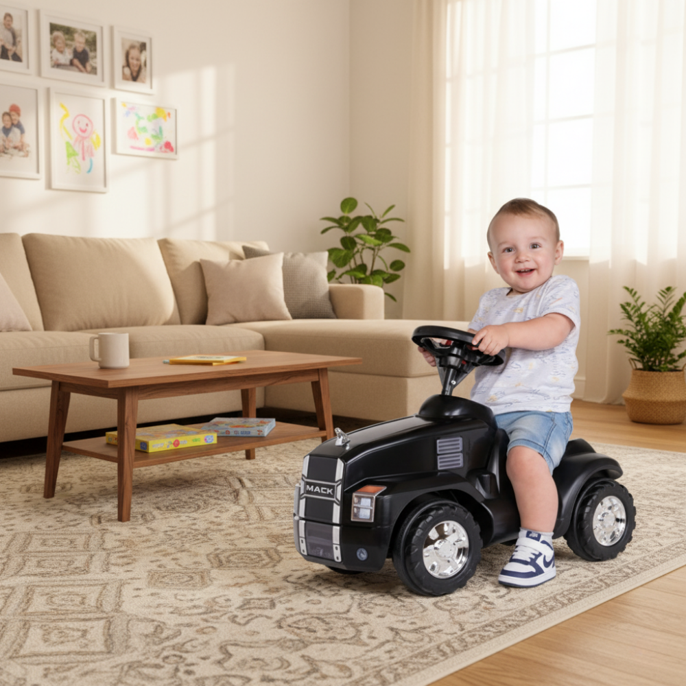 Child playing with a toy truck in a living room