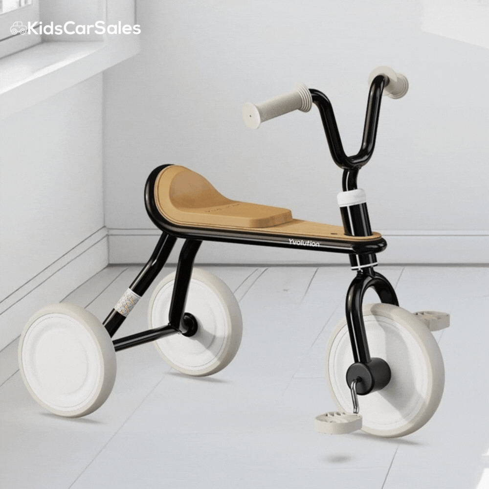 A black and tan Yvolution Velo Trike with white wheels rotates 360 degrees against a clean, white indoor background.