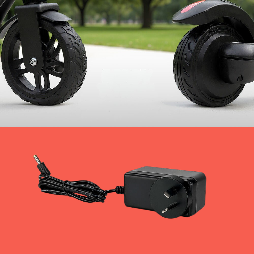Two black wheels of a scooter on a road with a power adapter on a red background.
