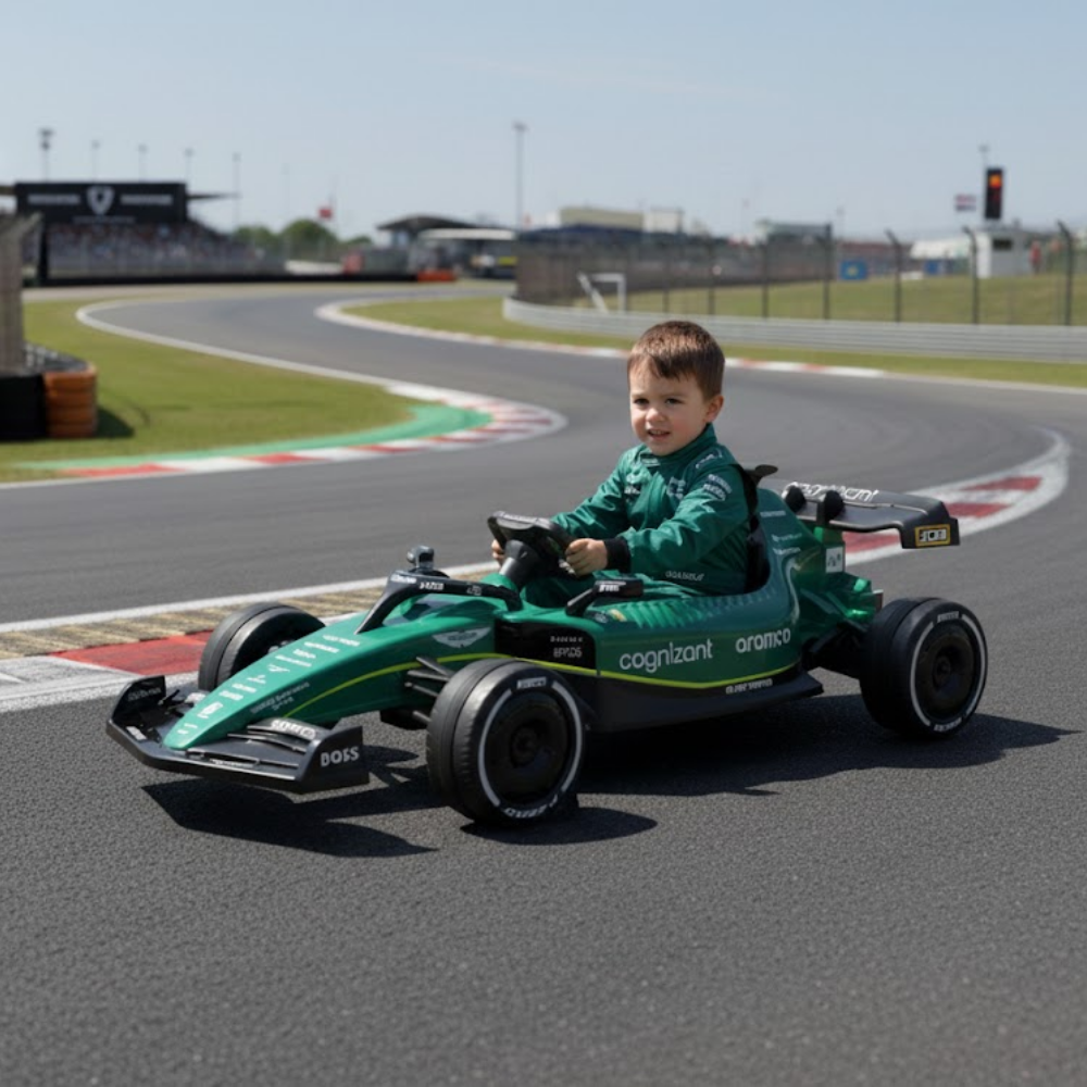 Child in a green toy Formula 1 car on a race track