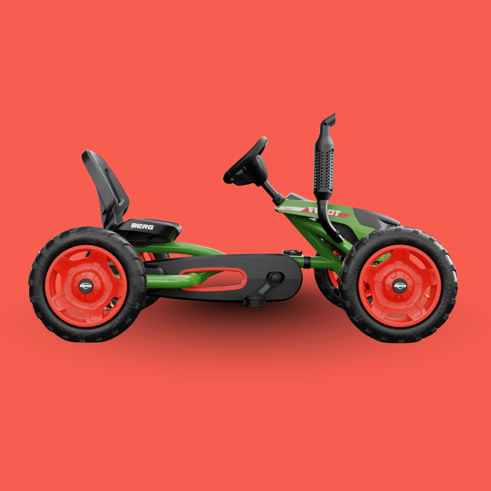 Toy go-kart with red wheels on a red background