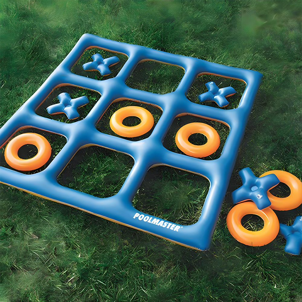 An inflatable Tic-Tac-Toe game placed on grass. The blue grid is filled with orange 'O' pieces and blue 'X' pieces, with some pieces placed on the grass next to the game