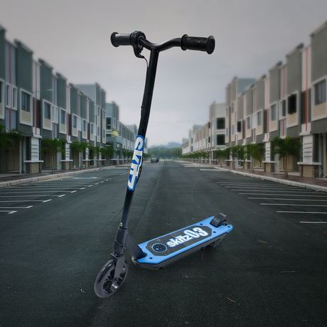 Lifestyle Image in Urban Setting: The scooter is shown outdoors on an empty street surrounded by contemporary buildings, emphasizing its suitability for urban commuting.