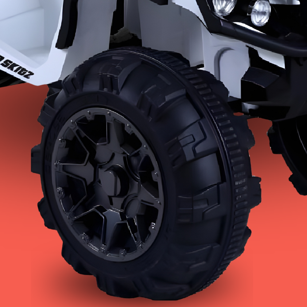 Close-up of a black tire on a toy vehicle with a red background