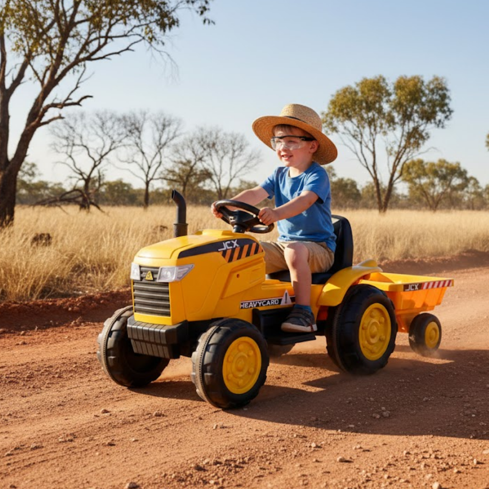Child driving a yellow toy tractor in a desert-like setting