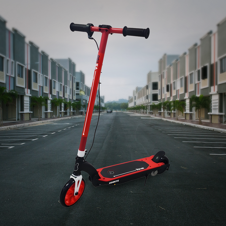 Lifestyle Image in Urban Setting: The scooter is shown outdoors on an empty road surrounded by modern architecture, emphasizing its sleek and urban-ready appeal.