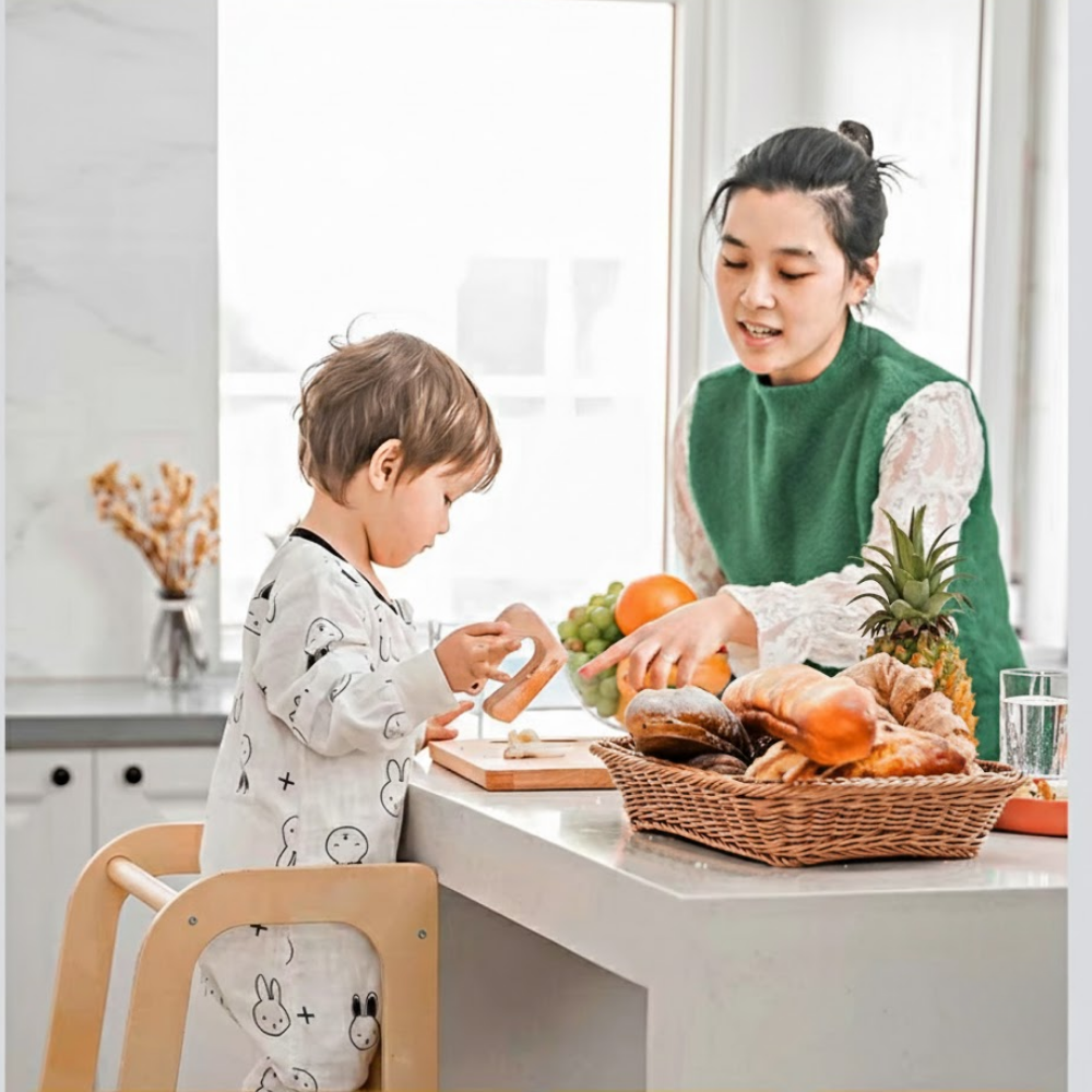 Woman and child in a kitchen preparing food together.