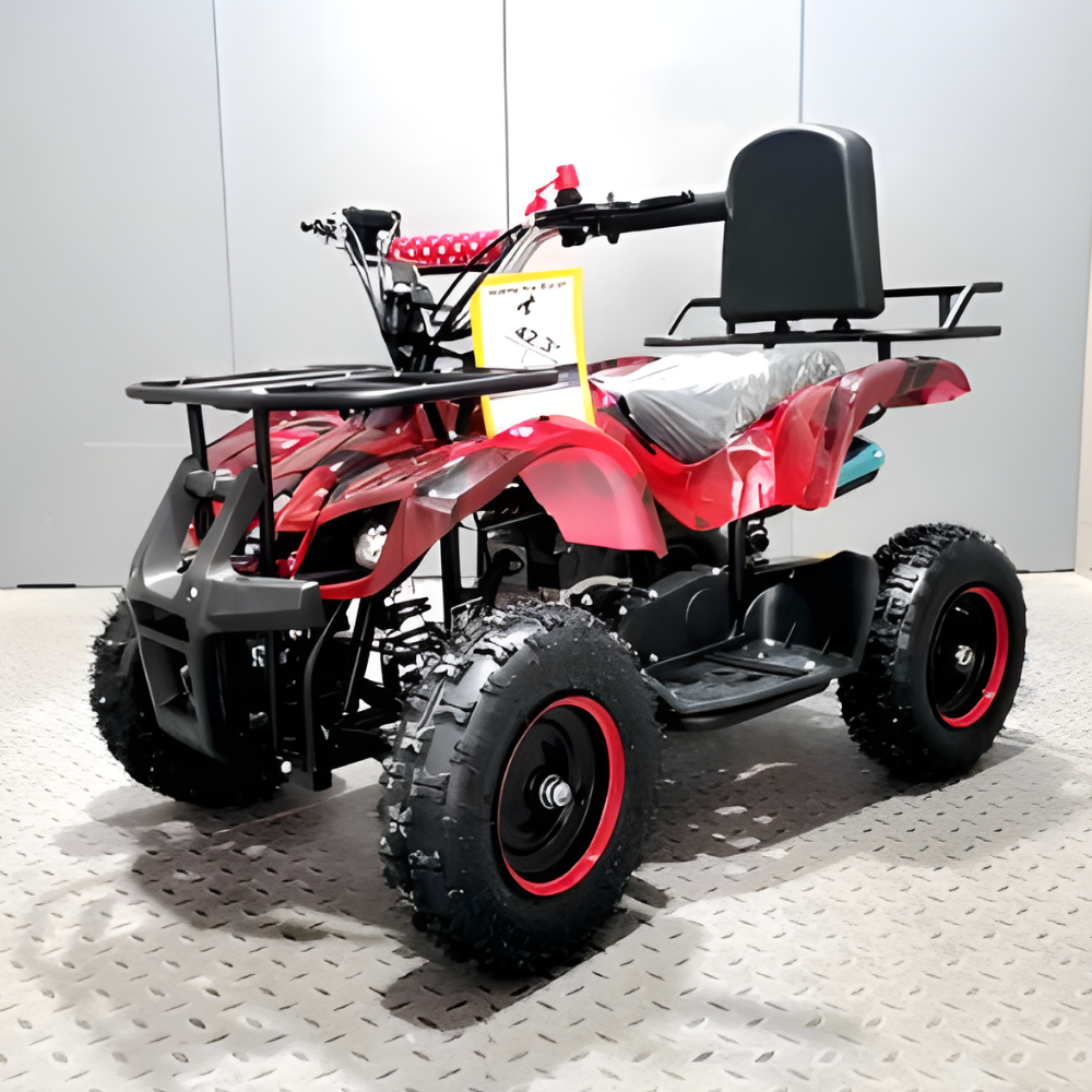 Red and black ATV on a white floor with a gray wall background