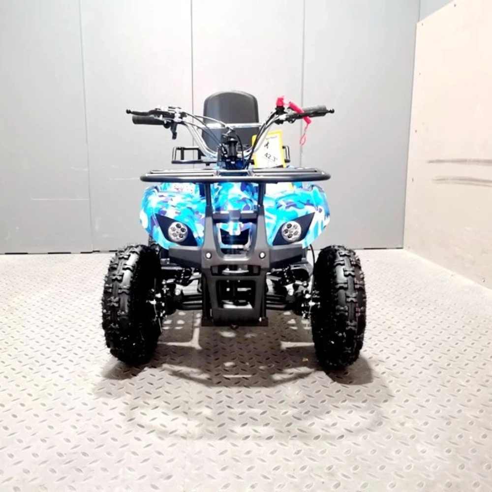 Small blue ATV on a textured surface