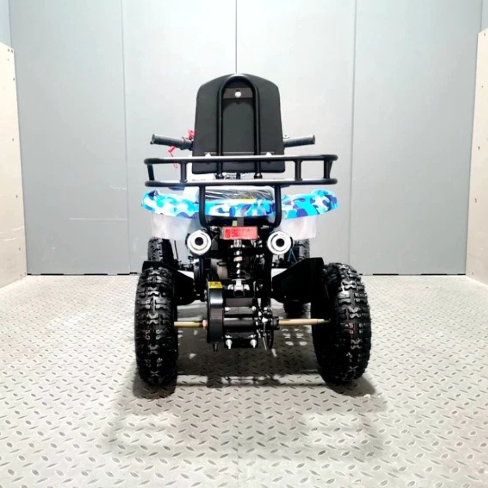 toy quad bike with lights on a textured floor against a plain wall
