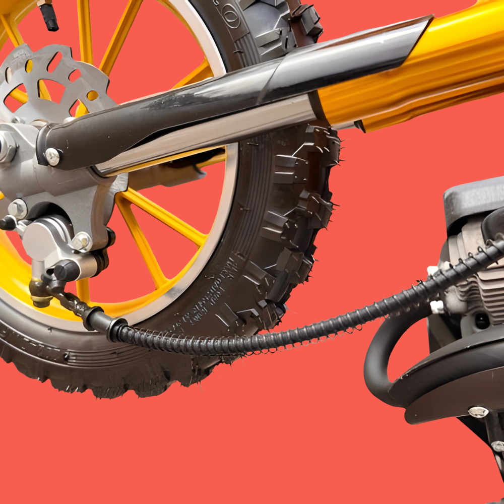 Close-up of a motorcycle's rear wheel and suspension on a red background