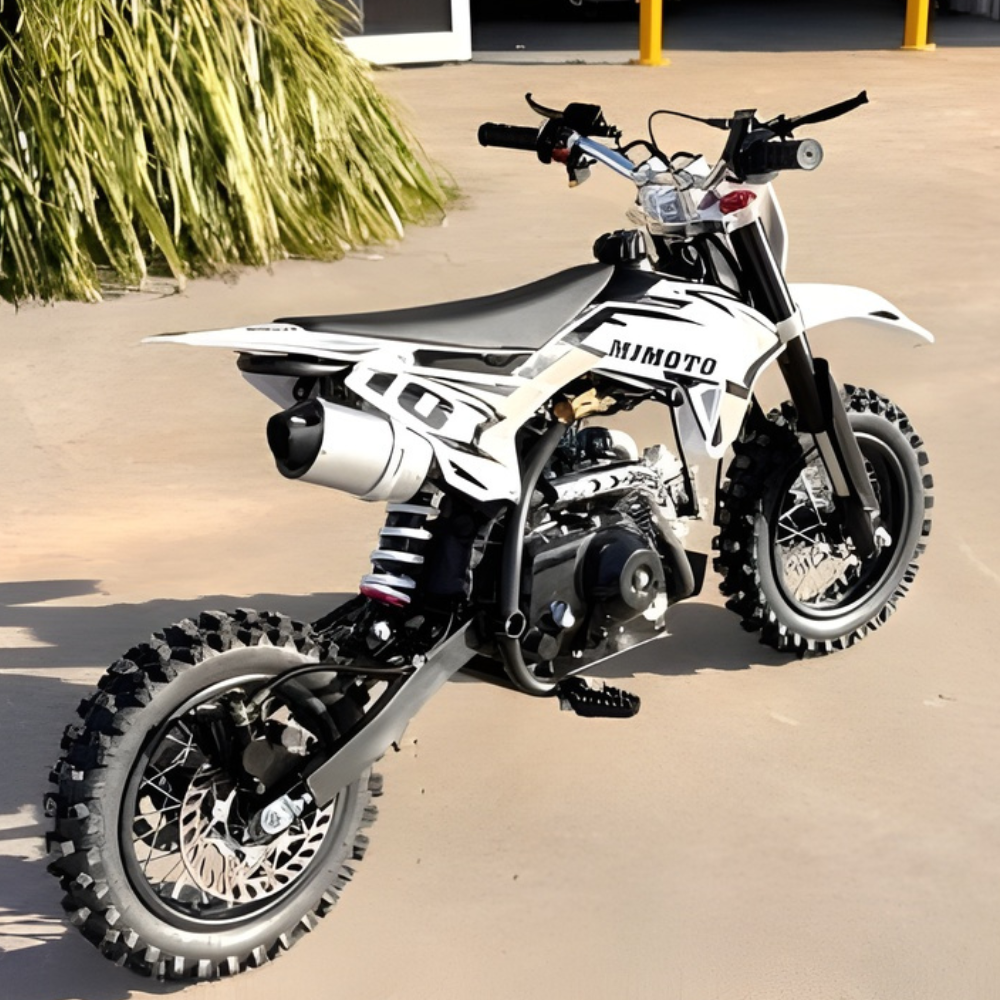 White dirt bike with black accents on a sandy surface