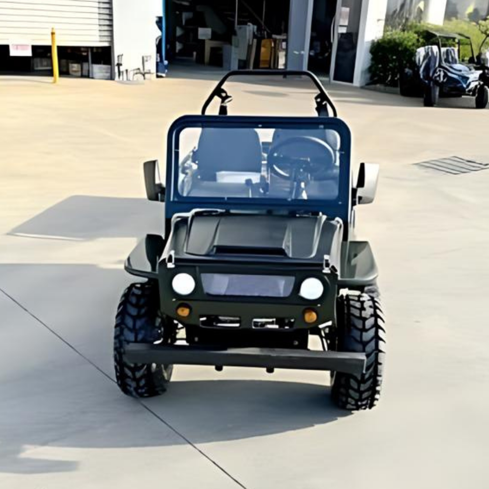 Small off-road vehicle on a concrete surface with a building in the background