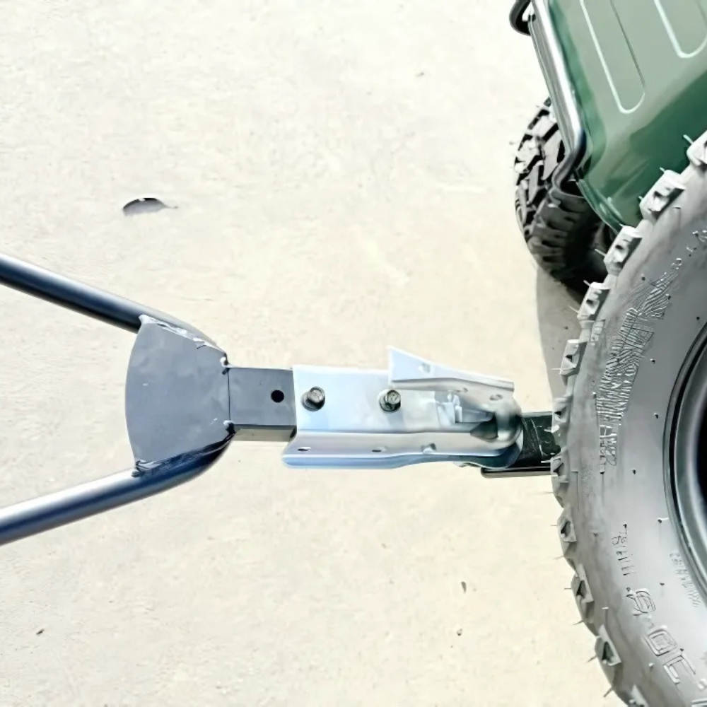 Close-up of a wheel and metal jack on a vehicle, with a white background.