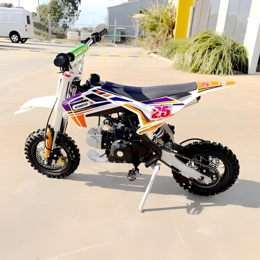 Colorful dirt bike on a stand in an outdoor setting