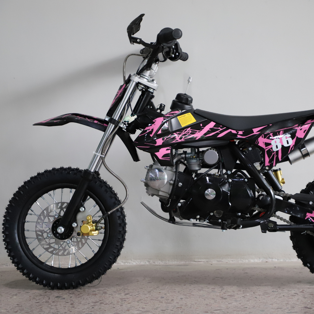 Left-side view of the dirt bike, showing kickstand down and full profile with visible engine and frame.