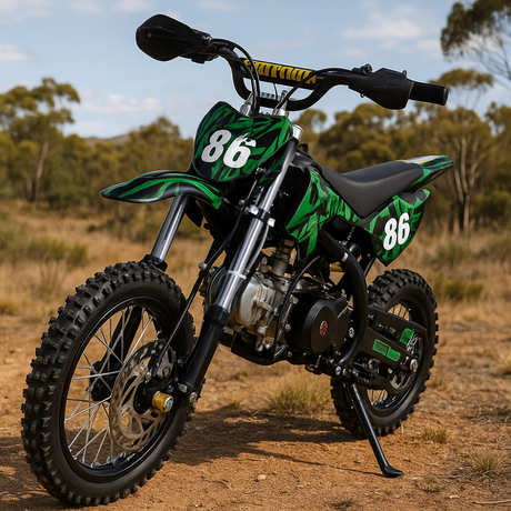 Outdoor shot of red and black dirt bike on dirt terrain with trees in the background, positioned front-left to show tread and stance.