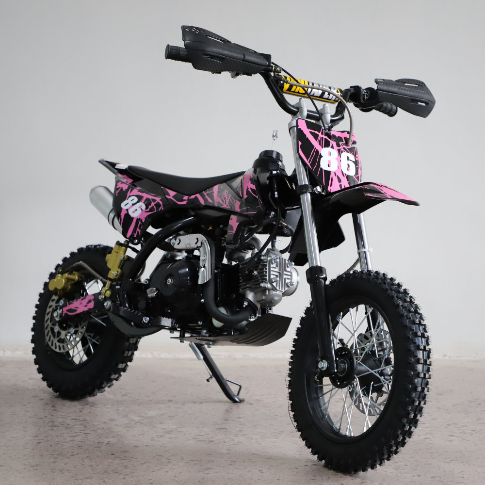 Right-side close-up view of the dirt bike, focusing on engine detail, swingarm, and chain area.