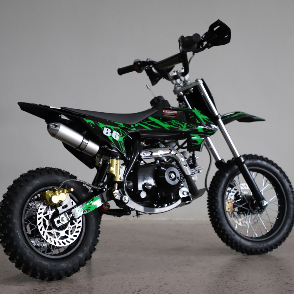 Right-side close-up view of the dirt bike, focusing on engine detail, swingarm, and chain area.