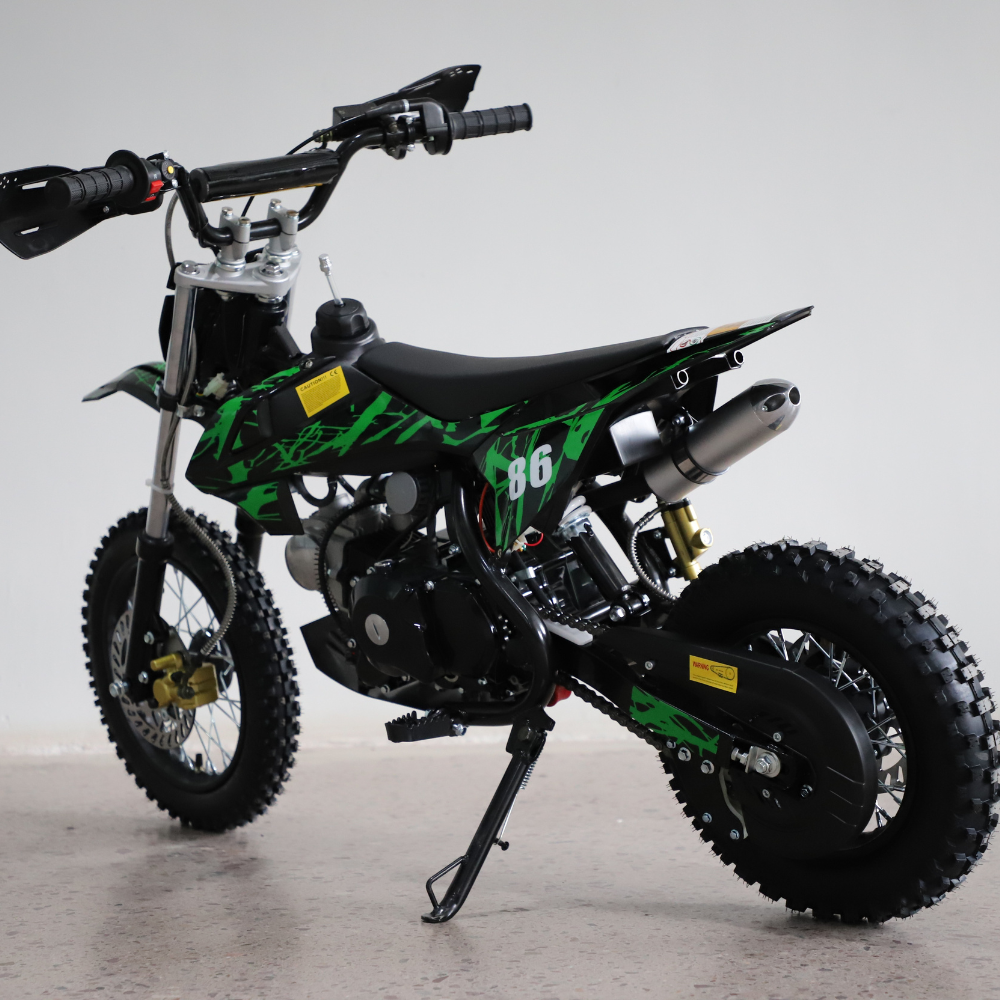 Left-side studio image of the dirt bike, highlighting fuel tank, seat contour, and red graphic styling.