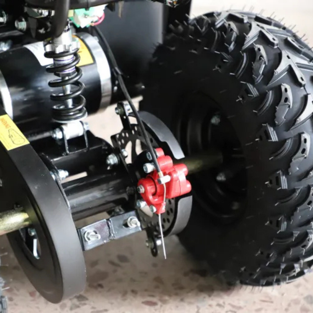 Close-up of a mechanical component with a red part on a vehicle.
