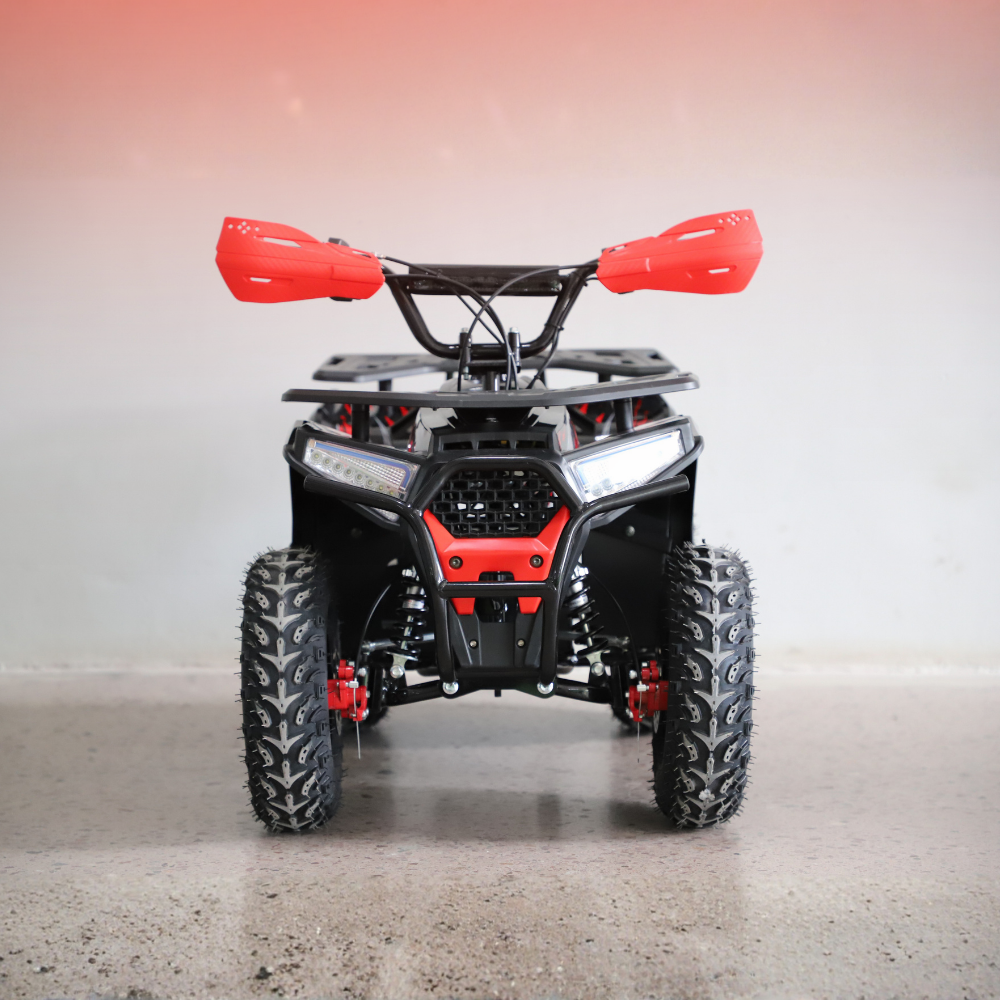 Front view of a red and black ATV on a gray surface with a gradient background