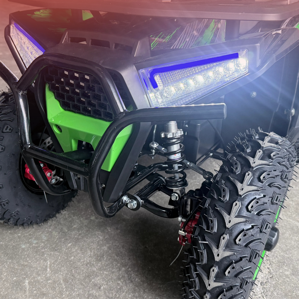 Close-up of an ATV with a focus on the front wheel and suspension system.