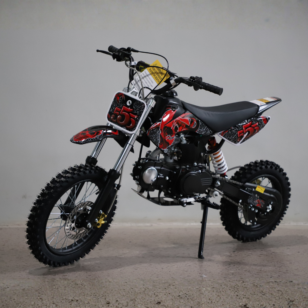Children's dirt bike with red and black design on a gray background