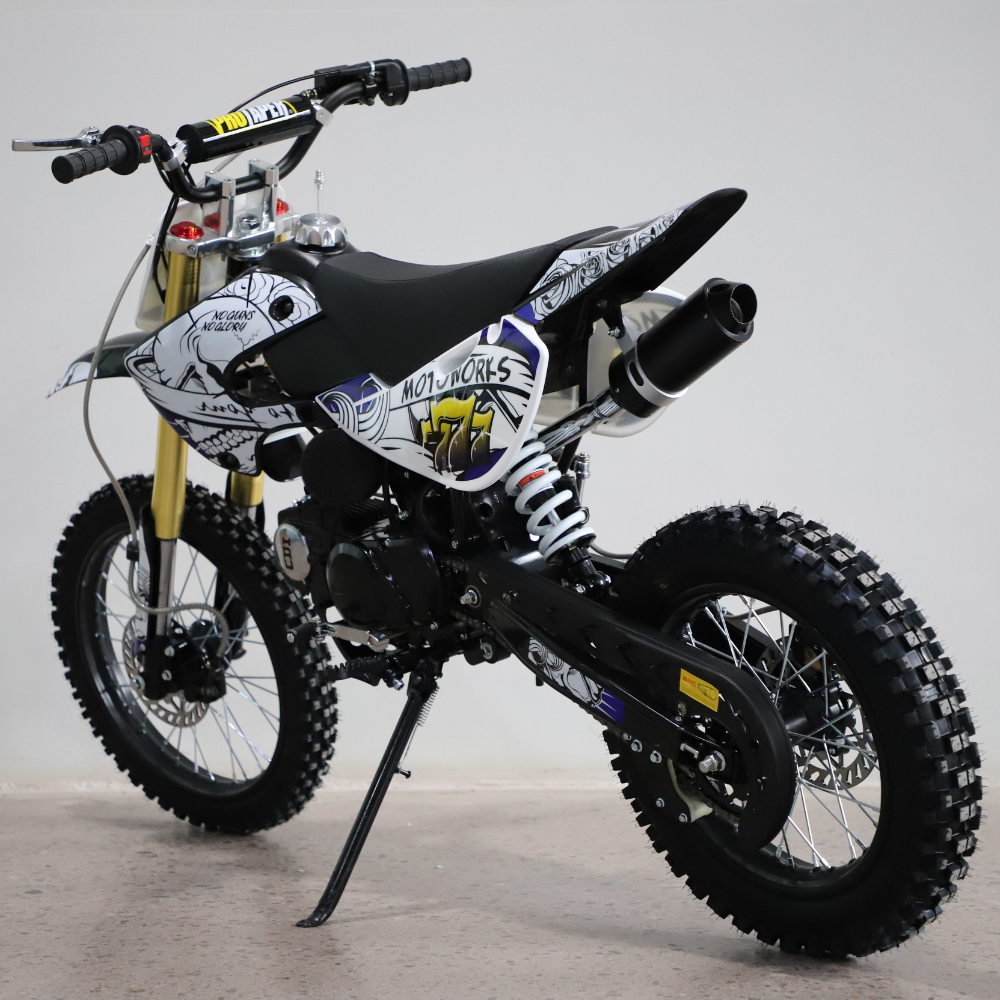 Three-quarter view of the dirt bike, highlighting frame structure and stance.