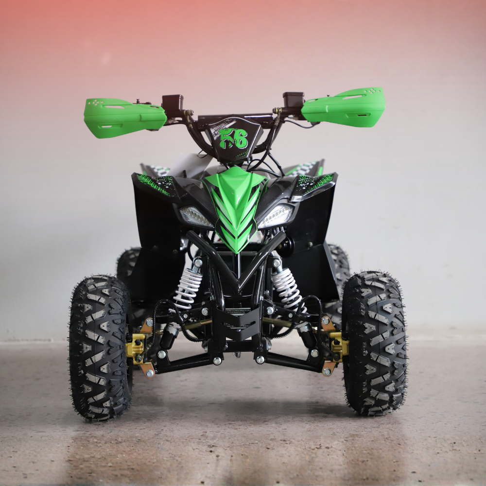Green and black ATV on a gray floor with a gradient wall background