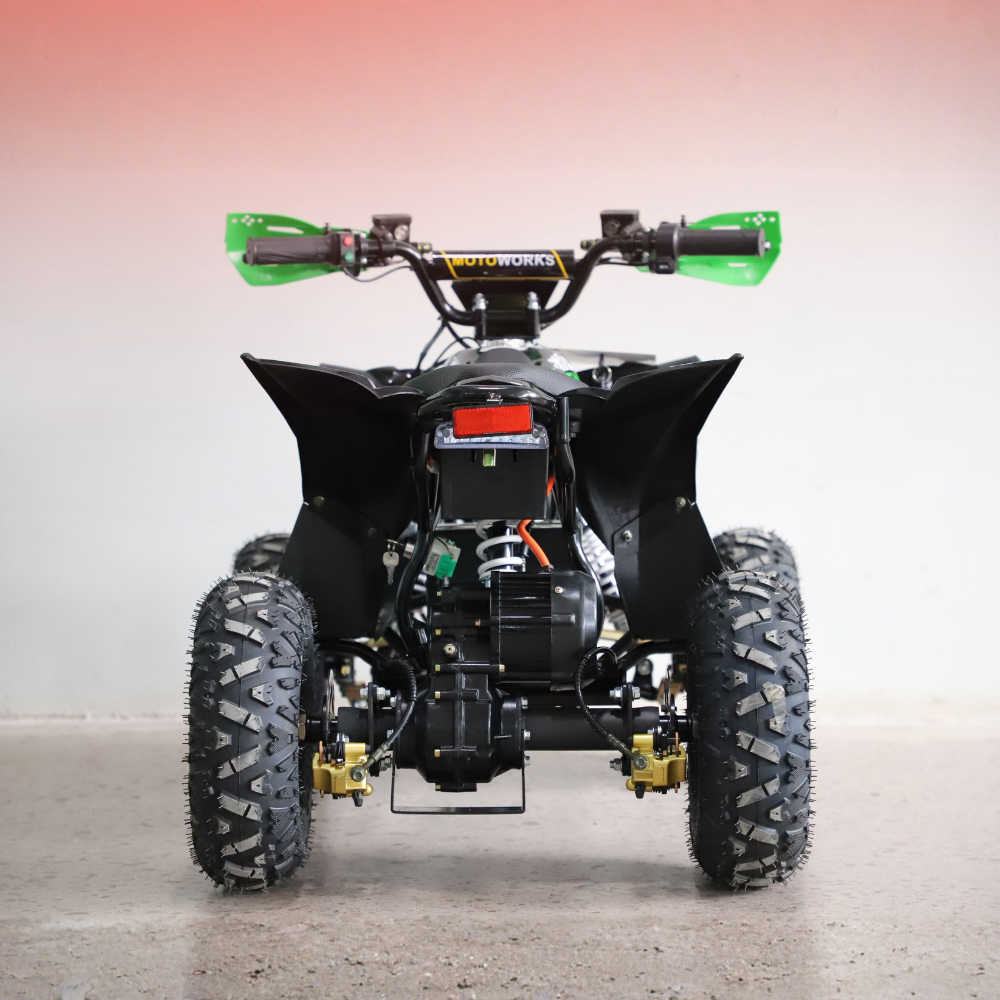 Black ATV with green handlebars on a gray background