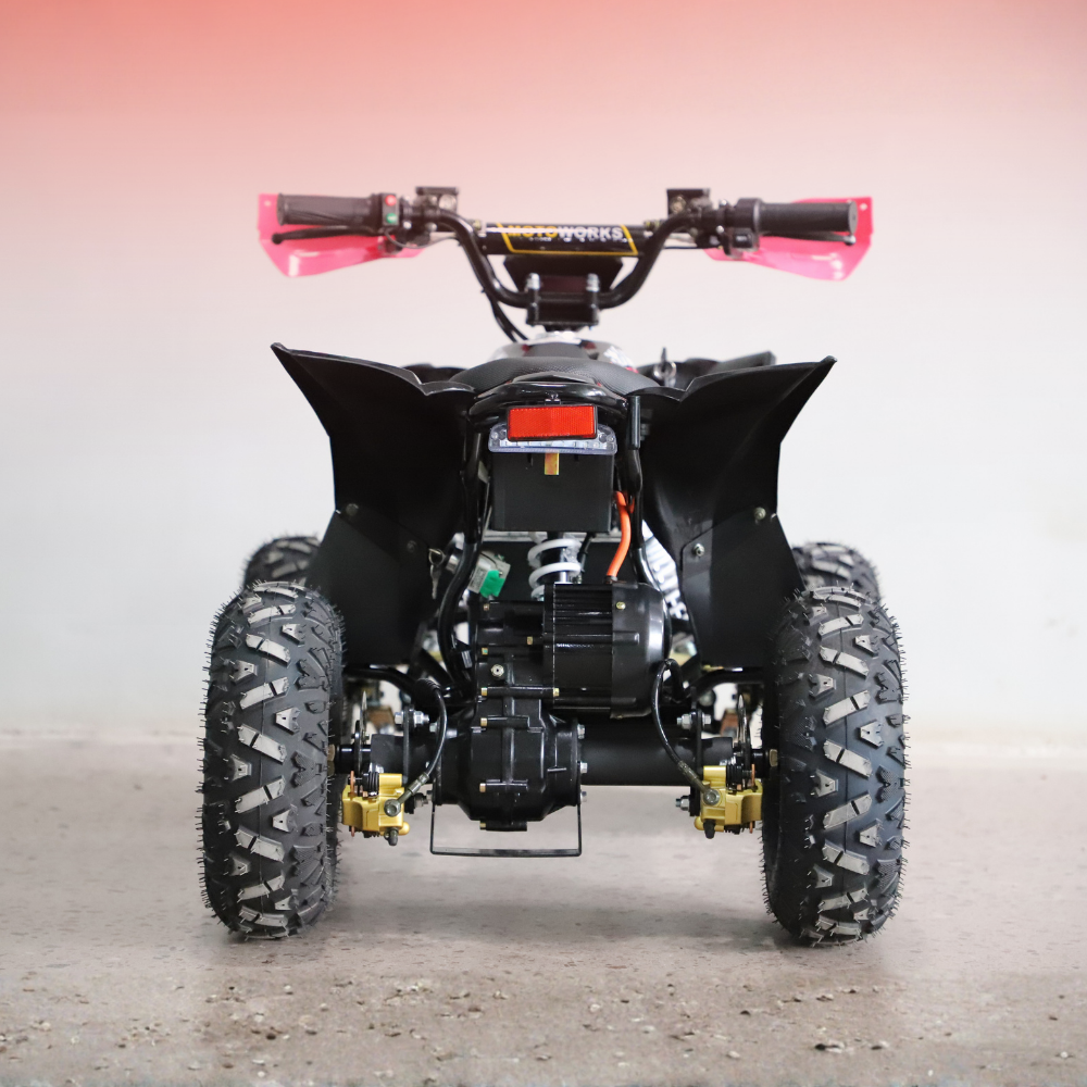 Black ATV with large tires on a gray surface