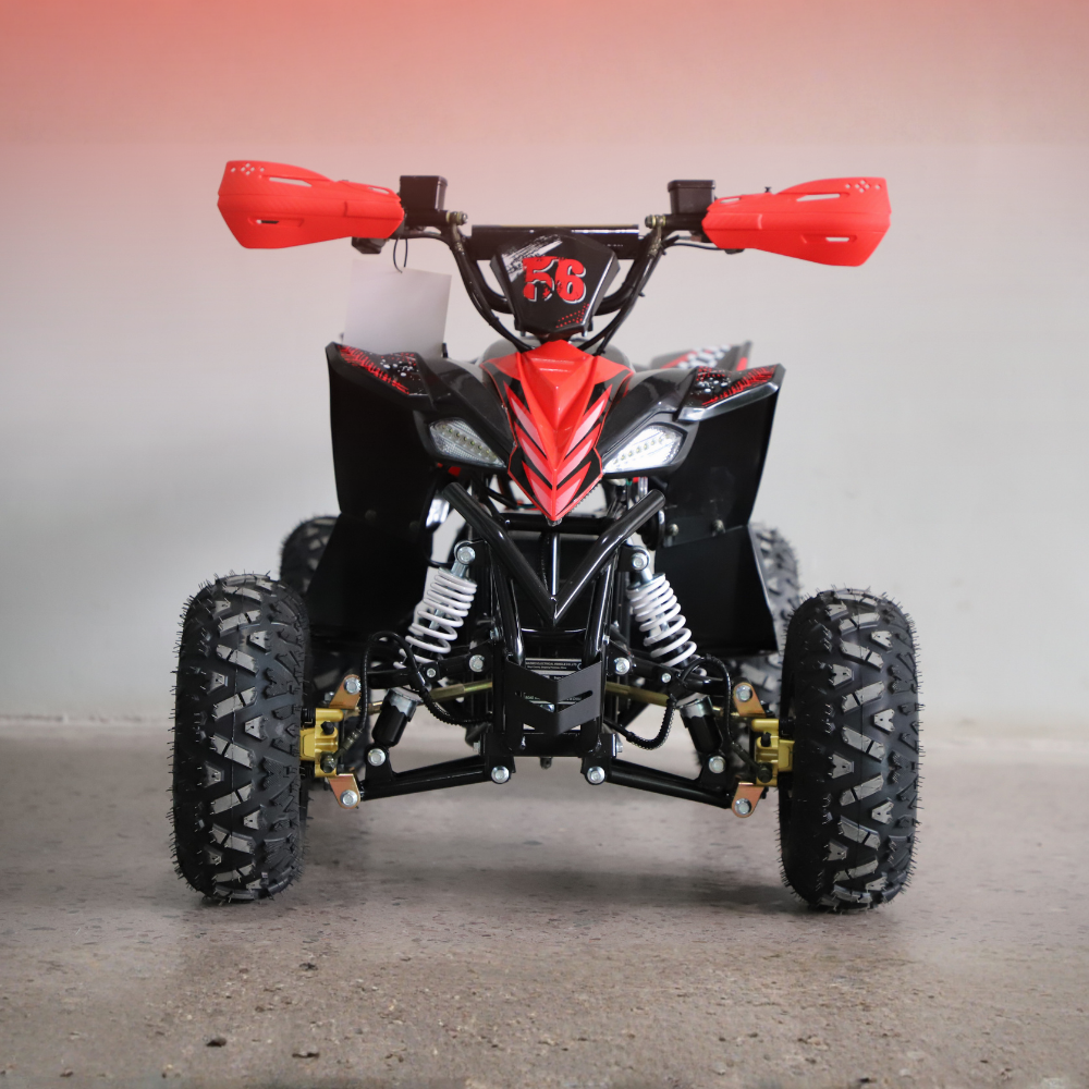 Red and black ATV on a gray surface with a gradient background