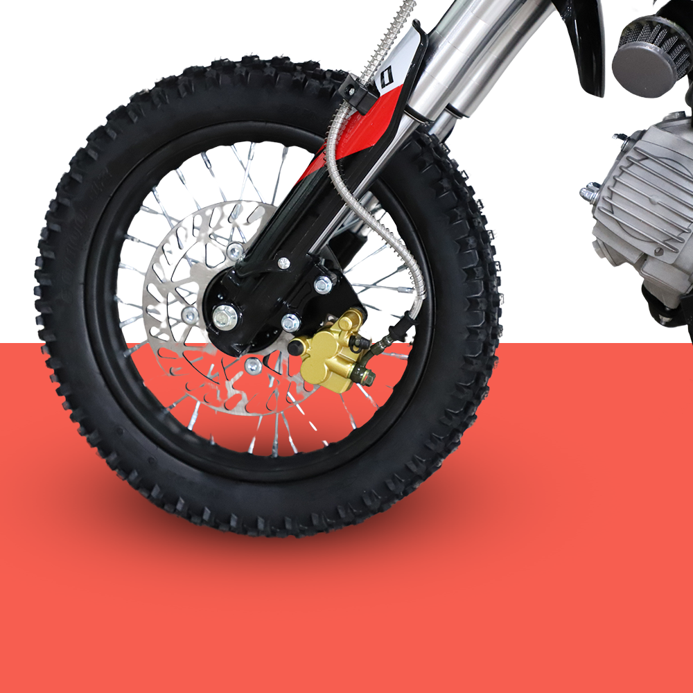 A detailed view of the front wheel, showing the tyre tread, disc brake, and gold-coloured suspension