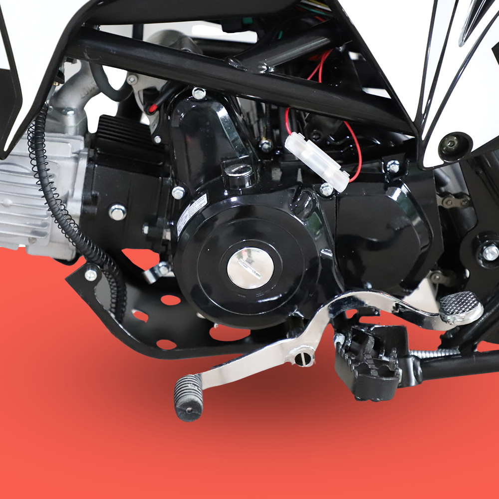 A close-up of the dirt bike’s front wheel and suspension, highlighting the braking system and tyre tread.