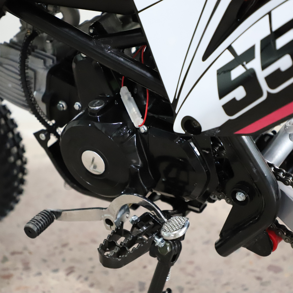 Close-up of a motorcycle's foot pegs and chain area with 'SS' branding.
