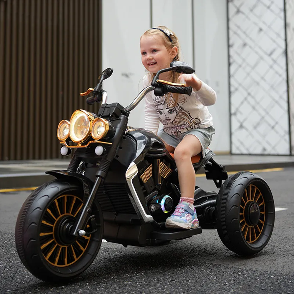 Close-Up Lifestyle Shot: A close-up of a child riding the black motorcycle, highlighting the detailed features like the headlights, handlebars, and large tires, while capturing the joy on the child’s face.