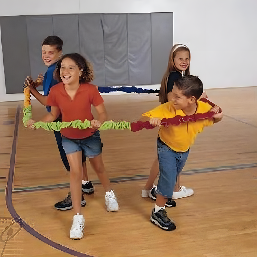 Kids engaged in a group game with the Soft Stretchy Rainbow Group Loop in a gym setting, illustrating indoor play and cooperative fun.