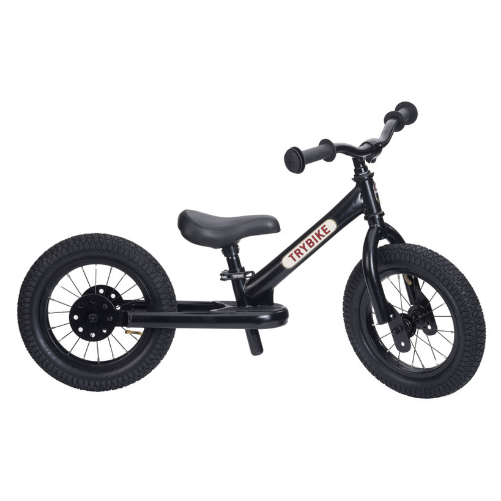 Black balance bike with 'TRYBIKE' branding on a white background