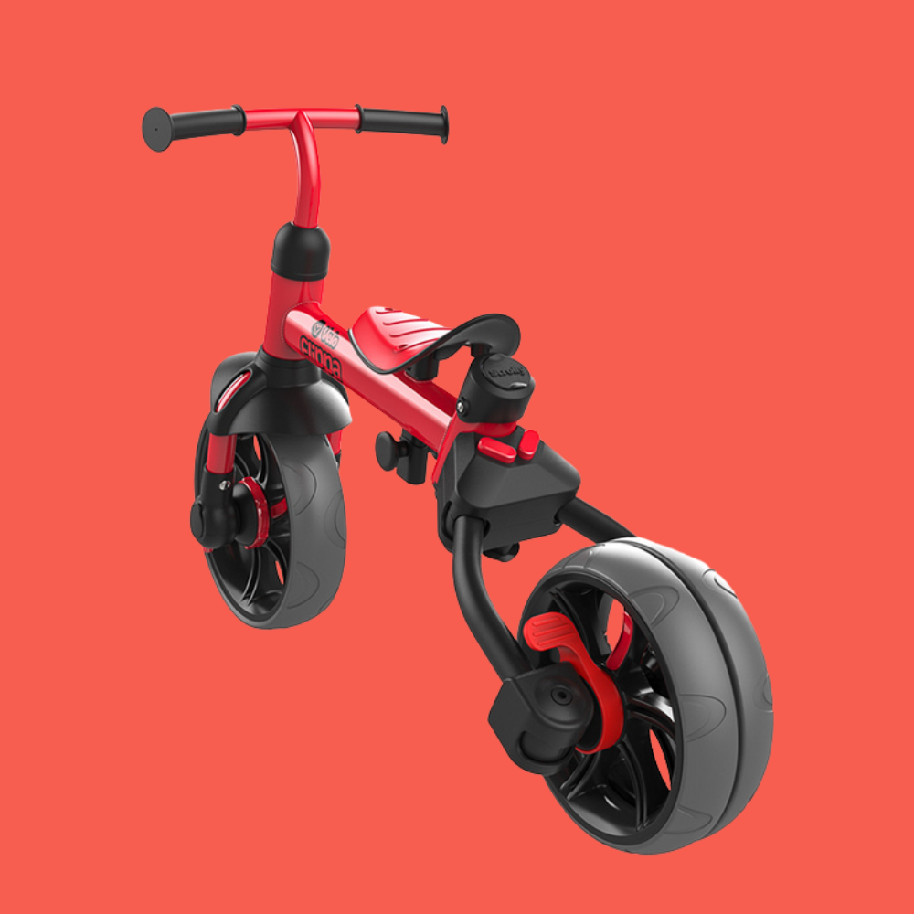 Red and black balance bike on a red background