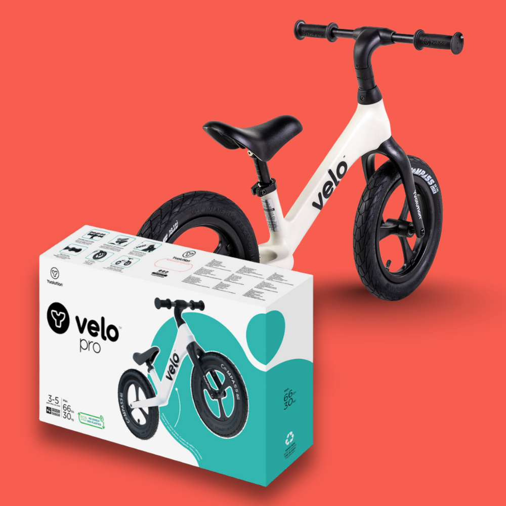 Children's balance bike and packaging on a red background